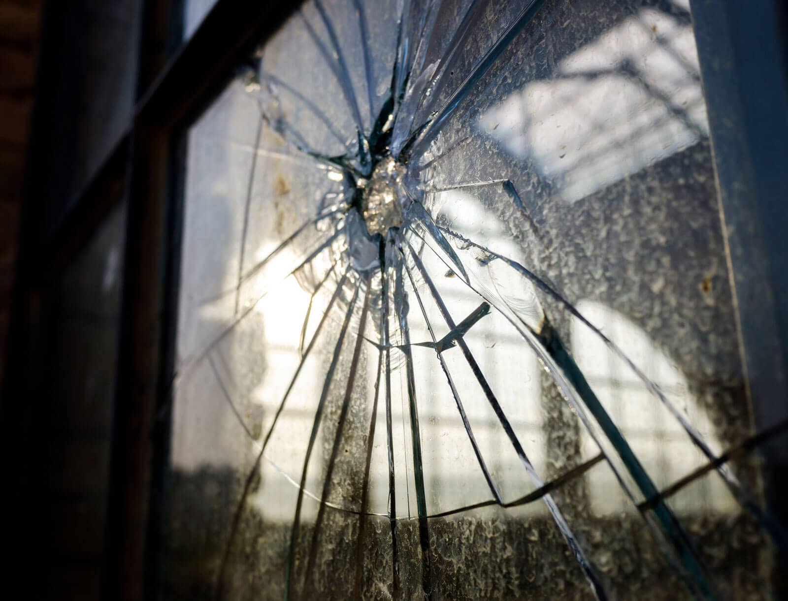 stoned window with broken glass of an industry